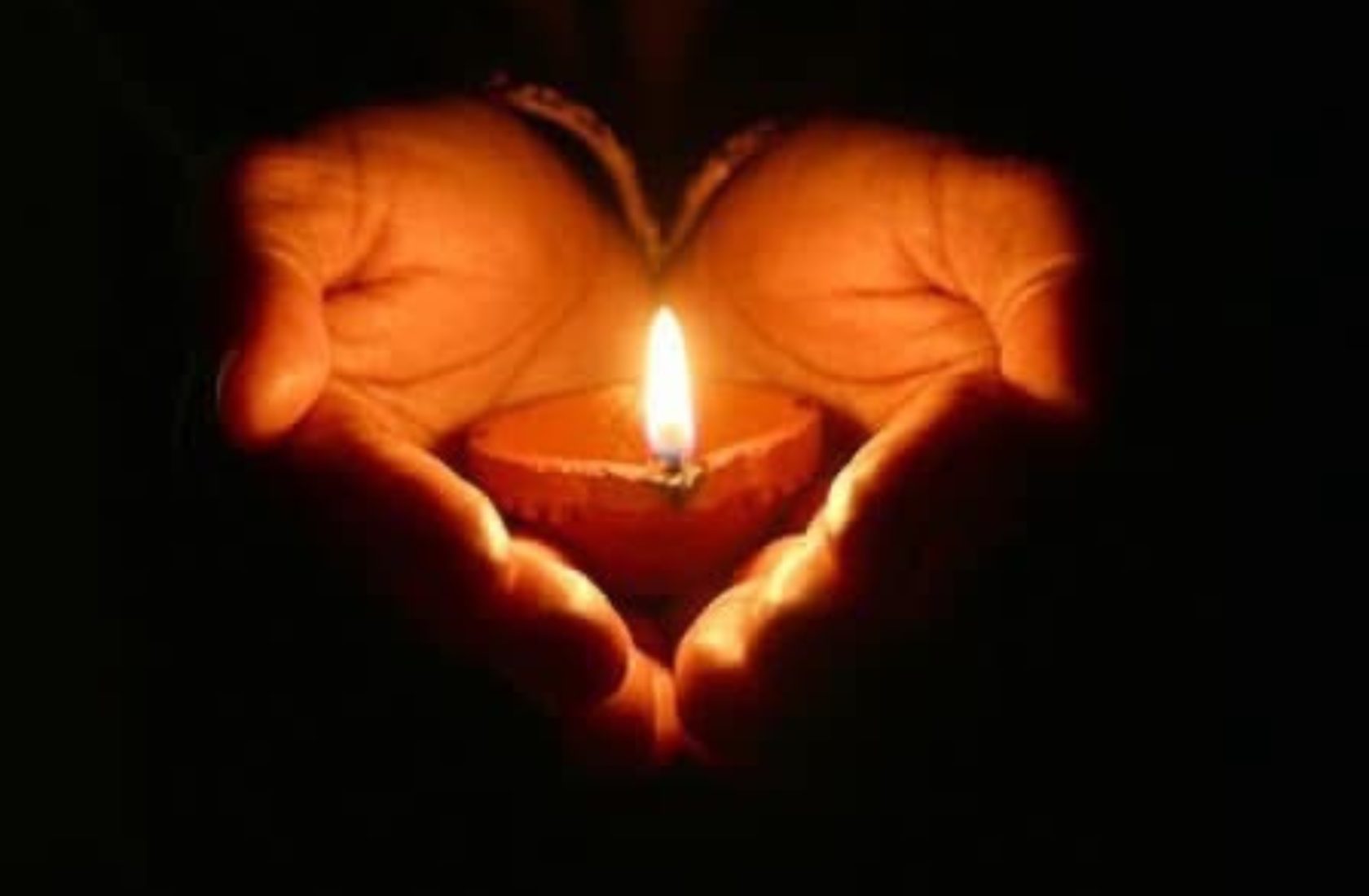 Candle held in two hands